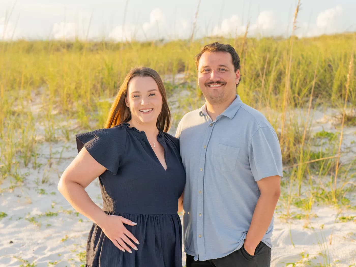 Preston Vawdrey and his wife Whitnee standing together on a beach at golden hour
